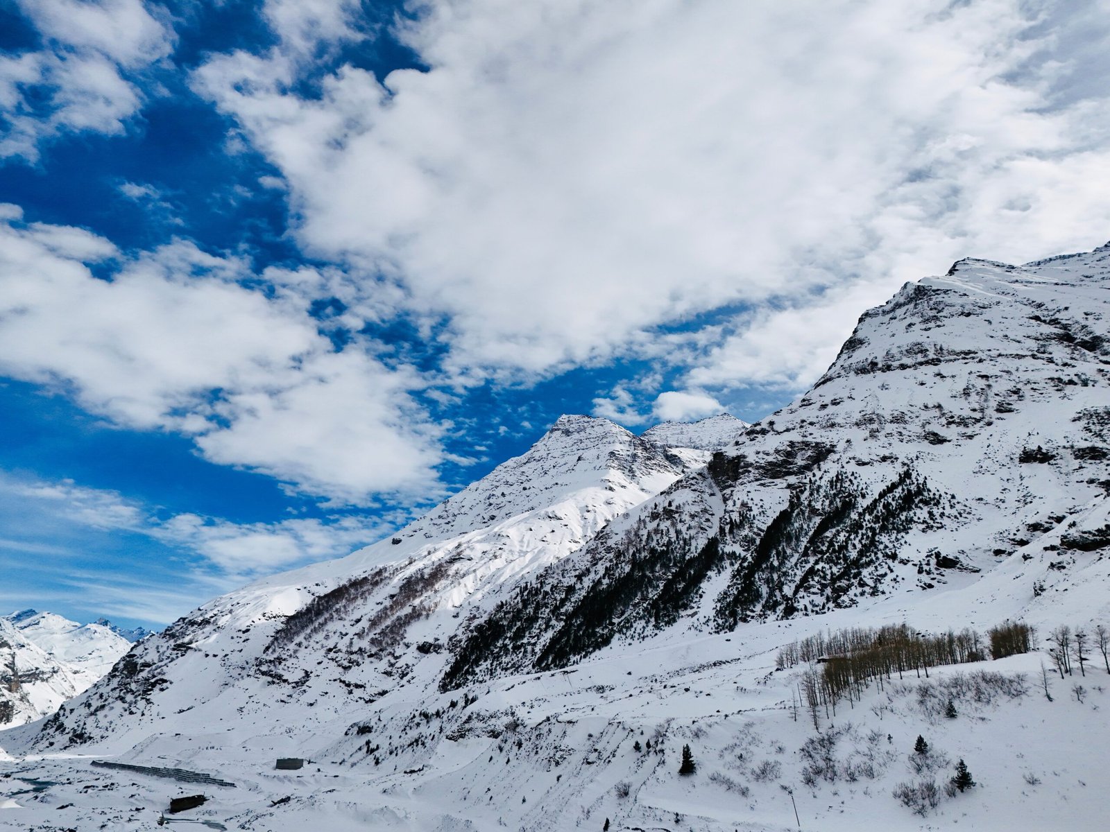 A breathtaking aerial shot of the snow-covered Himalayan mountains in Himachal Pradesh, India.
