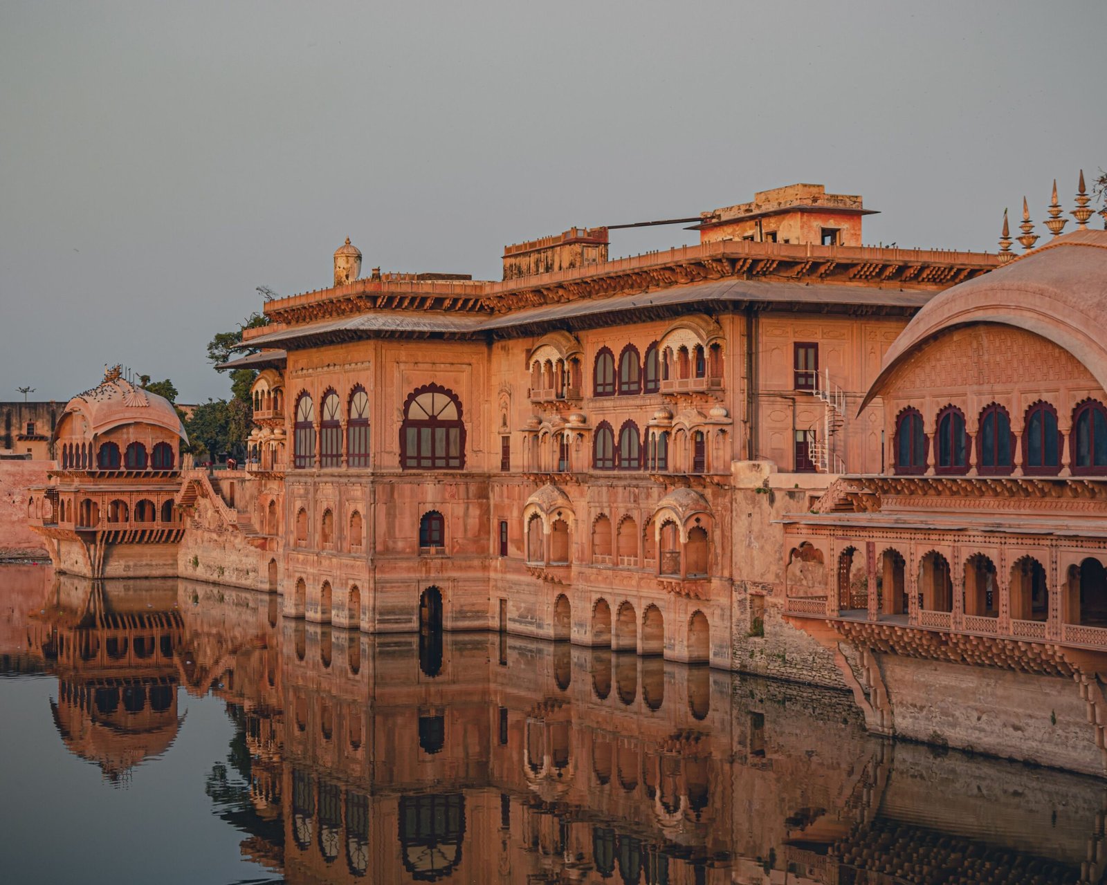 Stunning view of Deeg Palace architecture reflecting in the serene waters of Deeg, India.